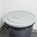 A Continental grey round trash can with a black lid.