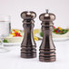 A Chef Specialties burnished copper salt and pepper shaker set on a table.