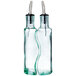 Two Tablecraft clear glass olive oil bottles with metal tips.