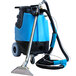 A blue and black Mytee 2002CS-230 Contractor's Special carpet extractor with a hose attached.