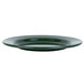 A close up of a Crow Canyon Home Stinson forest green speckle enamelware salad plate with a wide rim.