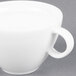 An Arcoroc white oversized cup with a handle.