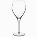 A close-up of a Luigi Bormioli Atelier red wine glass with a stem on a white background.