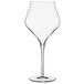A clear Luigi Bormioli Supremo wine glass with a long stem.