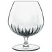 A clear Luigi Bormioli cognac glass with a stem.