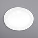 An International Tableware porcelain oval platter with a white rim on a gray surface.