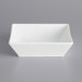 A white International Tableware square bowl on a gray background.