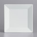 A white square International Tableware porcelain plate with a wide rim on a gray surface.