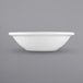 A white International Tableware porcelain fruit bowl with a rolled edge.