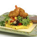 A plate of shrimp and vegetables with brown sauce on a table, breaded with Golden Dipt Tropical Rum Coconut Breader.
