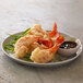 A plate of fried shrimp with Golden Dipt tempura batter and sauce.