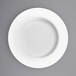 A close-up of a International Tableware Bristol bright white porcelain pasta bowl with a white rim.