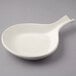 A white Tuxton china fry pan server with a handle.