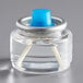 A clear glass jar with a blue top containing clear liquid.