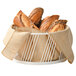 A Cal-Mil white wire basket filled with loaves of bread.