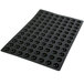 A black rubber baking mat with 96 half sphere cavities.