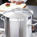 A Vollrath stainless steel domed cover on a large pot.