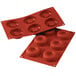 A red silicone baking mold with six big savarin cavities.