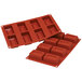 A red Silikomart silicone mold with rectangular compartments.