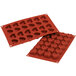 Two red heart-shaped Silikomart silicone baking molds.
