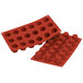 A red Silikomart silicone baking mold with 18 small square cavities.
