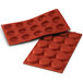 A red Silikomart silicone flan baking mold with 15 compartments.