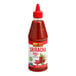 A close up of a bottle of Lee Kum Kee Sriracha Chili Sauce.