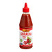 A close up of a Lee Kum Kee Sriracha Chili Sauce bottle.