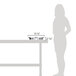 A woman using a Vollrath stainless steel round food pan in a chafer on a table.