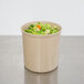 A beige Cambro crock filled with broccoli and carrots.