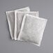 A group of white Bromley iced tea filter bags on a gray surface.