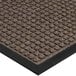 A white background with a close-up of a walnut brown Lavex waffle entrance mat with a black border.
