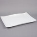 A white rectangular American Metalcraft stoneware platter with a wavy edge.