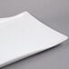 An American Metalcraft wavy rectangular stoneware platter with a curved edge.