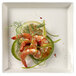 A Solia white square plate with shrimp and lemon slices on it.