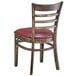 A Lancaster Table & Seating wood ladder back chair with a burgundy vinyl seat detached.