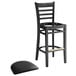 A Lancaster Table & Seating black wood ladder back bar stool with black vinyl seat.