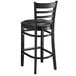 A Lancaster Table & Seating black wood bar stool with black vinyl seat.