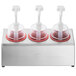 A Steril-Sil stainless steel 3-compartment condiment dispenser with red dome top pump lids over three cups.