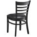 A Lancaster Table & Seating black wood ladder back chair with black vinyl seat