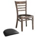 A Lancaster Table & Seating wooden ladder back chair with a detached black vinyl seat