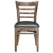 A Lancaster Table & Seating wooden ladder back chair with black vinyl seat on a white background.