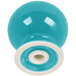 A turquoise ceramic pepper shaker with a white circle on the bottom.