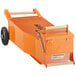 An orange metal cart with wheels and a handle.