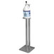 An Advance Tabco aluminum stand with a bottle of hand sanitizer on it.