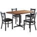 A brown wood Lancaster Table & Seating butcher block table with four black chairs.
