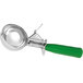 A silver and green Carlisle ice cream scoop with a metal thumb press.