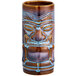 A close up of a brown ceramic Tiki mug with a blue face.