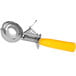 A silver metal ice cream scoop with a yellow handle.