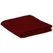 A folded burgundy Intedge square table cover on a white background.